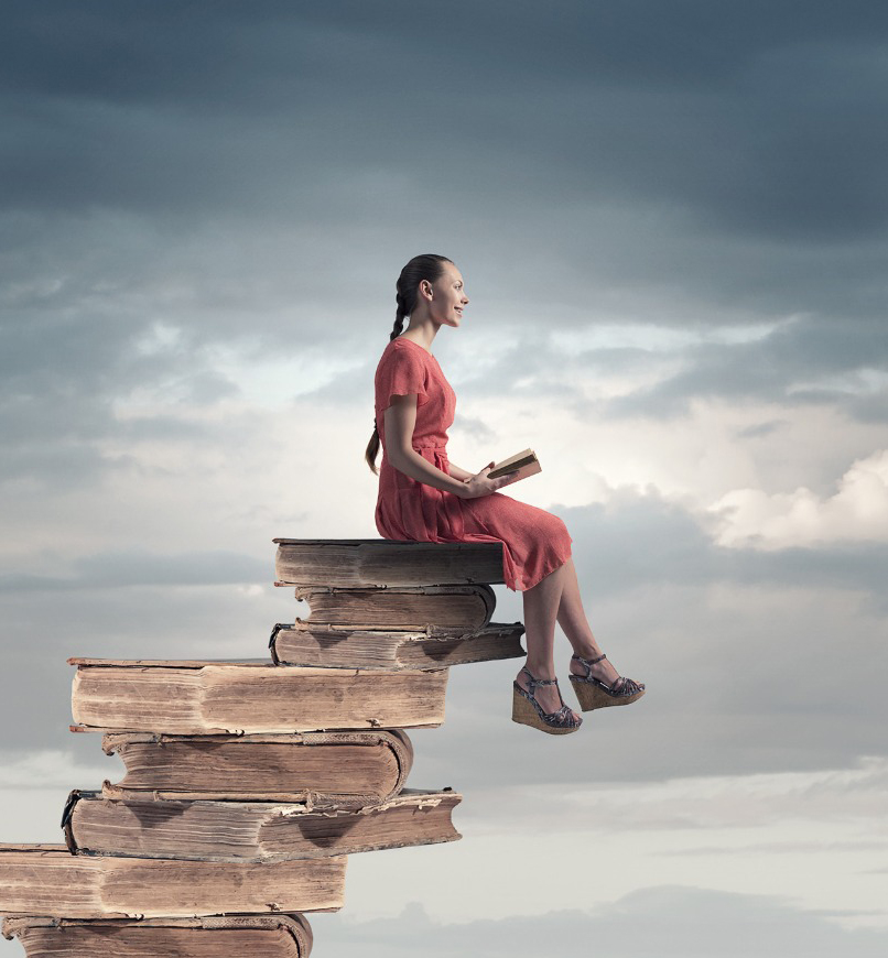 Girl sitting on stack of books